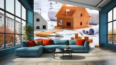 A scene featuring architectural model houses, blueprints, and various tools, representing the concept of home construction, design, and building planning. Wall mural