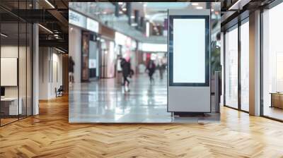 wider perspective of a bustling shopping mall, emphasizing a digital advertising display. The scene is captured in a soft focus, portraying the dynamic and busy nature of modern retail environments. Wall mural