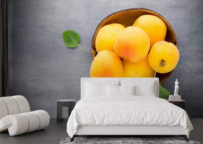 Apricots with leaves on the old wooden table. Wall mural