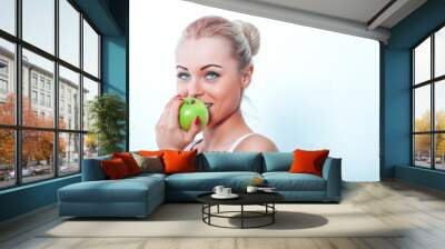 Beautiful woman eating green apple isolated on white background Wall mural