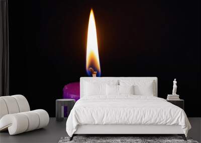  Purple candle burning with streaks of paraffin on dark background Wall mural