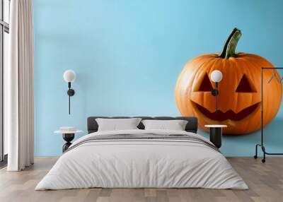 A Halloween Jack O Lantern isolated on a pale blue background, copy space on a side Wall mural