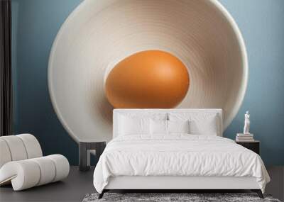 Single egg in the white bowl with blue background, copyspace on a side Wall mural