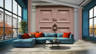 Door number 54 (fifty four). Metal plate on pink wooden door Wall mural