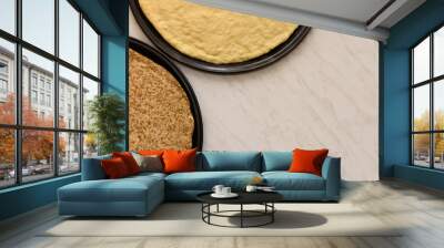 Preparation of pizza, two round baking tray with traditional or whole wheat flour pizza dough, flat composition on a white table with space for text entry Wall mural