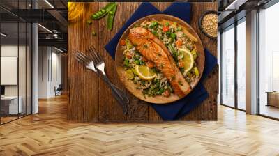 Asian dish. Fried salmon with rice and vegetables. Sprinkled with sesame seeds. Wall mural