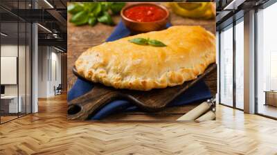 Italian calzone with mushrooms and ham. Wall mural