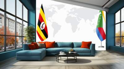 Uganda and Comoros flags for official meeting against background of world map. Wall mural