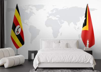 Uganda and East Timor flags for official meeting against background of world map. Wall mural