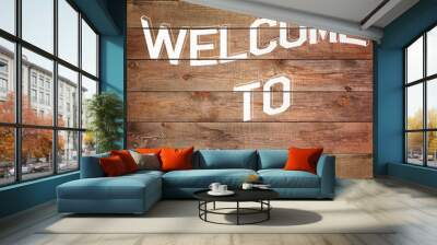 Vintage WELCOME sign on natural wooden surface. Wall mural