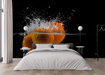 three tangerines fall into the water on a black background, copy space Wall mural