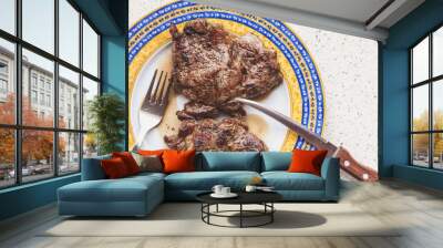 plate with two succulent steaks stands on gray table Wall mural