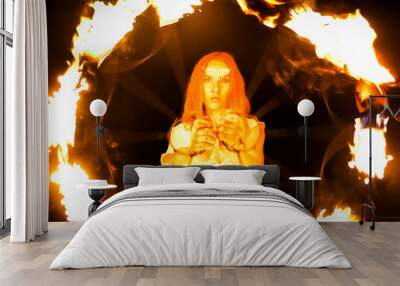 Fire woman dancing with burning fans Wall mural