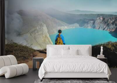 Woman standing on edge of crater  Kawah Ijen volcano, East Java, Indonesia Wall mural