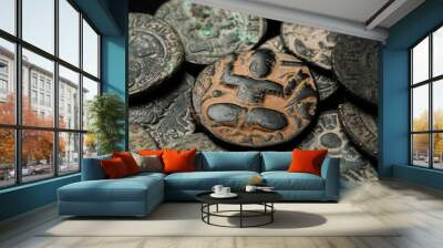 Ancient islamic copper coin in pile of other coins Wall mural