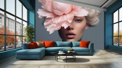 A surreal portrait of a dreamy woman adorned with pastel flowers, evoking a sense of ethereal beauty and wonder. Peony flower covering her face, natural beauty face care concept. Wall mural