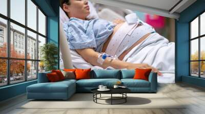 A woman in labor, giving birth in the hospital. Childbirth and pregnancy. Wall mural