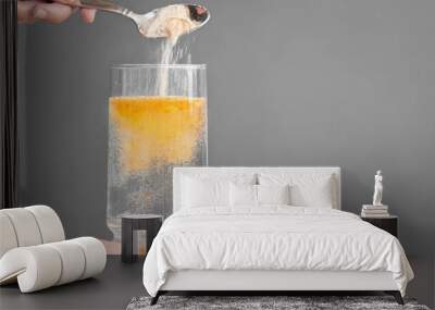 Orange fizzy powder and water glass with copy space. Healthy supplement. Wall mural