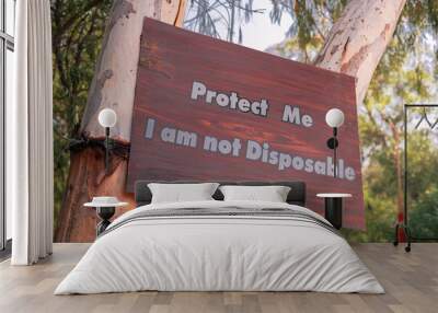 Protect me I am not disposable A sign board with message on a tree Save tree save planet Save nature save trees Wall mural