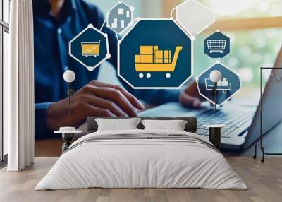 A person uses a laptop surrounded by digital shopping cart and graph icons, representing online shopping, data analysis, and modern technology trends. Wall mural