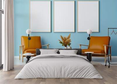 A stylish living room with two orange mid-century modern armchairs, a round wooden coffee table, and minimalist decor elements set against a light blue wall. Wall mural