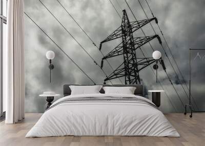 Power line pylon against the background of the dark cloudy sky Wall mural