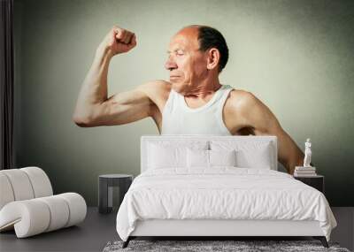 funny senior man showing the muscles Wall mural