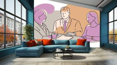 A man and two women are sitting at a table Wall mural