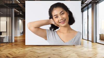 Dental brace teen girl smiling looking on a camera. white teeth with blue braces. Dental care. Asian woman smile with orthodontic accessories. Cosmetic dentistry, orthodontics treatment. studio shot. Wall mural