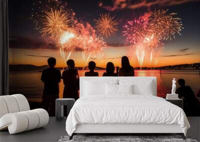 Silhouette of people watching fireworks on the beach Wall mural