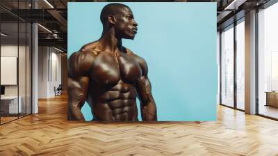 muscular bodybuilder athlete man with perfect body and naked torso posing on blue background, bodybuilding athletic african american black male studio shot Wall mural