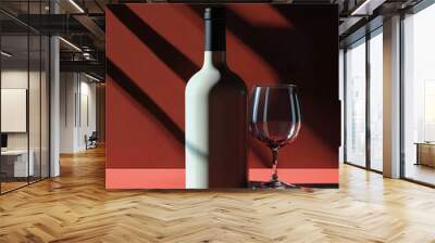 A bottle of white wine and a wine glass are sitting on a red table against a red background.

 Wall mural