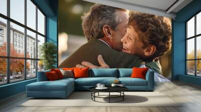 an adult son hugs his father cheerfully in the yard, with a smile of family love Wall mural