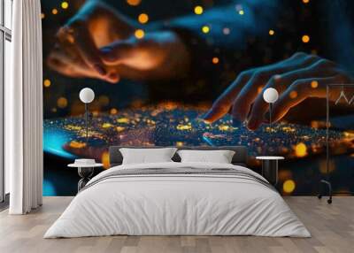 Person's hands using a tablet device with an illuminated screen and golden lights. Wall mural