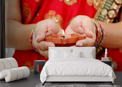 Hands holding a traditional Indian oil lamp Wall mural