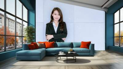 Asian beatiful young business woman in suit skirt using tablet to work about sales and marketing plan Wall mural