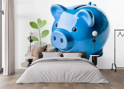 a blue piggy bank with a plant growing on top of coins Wall mural