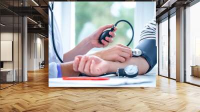 Doctor measures the blood pressure to patient during a medical examination and consultation in the hospital. Healthcare Wall mural