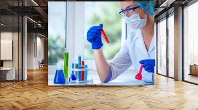 Female laboratory assistant conducts clinical laboratory research, holds test tubes in his hands. Medicine, pharmacy and cosmetology concept. Scientific glassware for test Wall mural