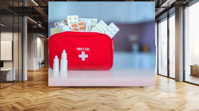 Medical first aid kit with medicine and pills on table at home Wall mural