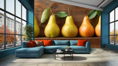 A group of nashi pears arranged on a wooden table with a natural, organic texture, their golden and green skins contrasting with the rustic wood, evoking a fresh and healthy summer feel Wall mural