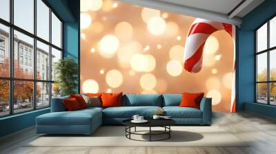 A minimalistic 3D icon of a candy cane with red and white stripes, set against a background of soft, out-of-focus holiday lights Wall mural