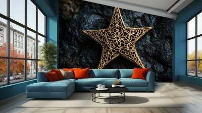 A stunning close-up of a gold star ornament, intricately designed, set against a textured dark surface, highlighting its beauty and luxury Wall mural