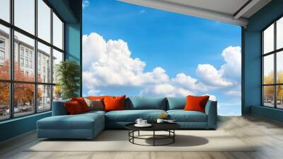 Sunny day with clear blue skies and cottony clouds, capturing the beauty of nature and the warmth of a summer day Wall mural