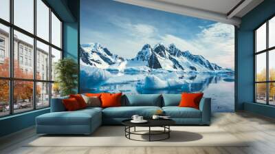 Blue Ice covered mountains in south polar ocean. Winter Antarctic landscape. The mount's reflection in the crystal clear water. The cloudy sky over the massive rock glacier. Travel wild nature Wall mural