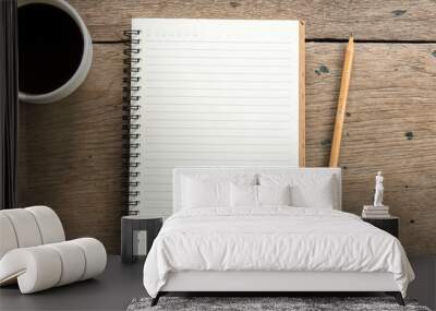 Top view of blank notebook with white coffee and natural light on wooden table. Wall mural