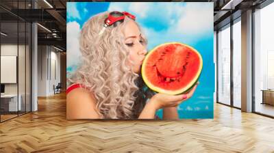 beautiful blonde young woman wearing red swim suit with watermelon on the beach Wall mural