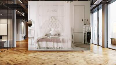 White bedroom interior with nobody. large cozy bed with a white canopy and oval dressing mirror with dressing table next to it Wall mural