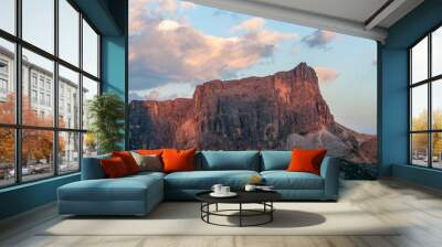 Sunset at the Passo di Giau, casting a red glow on the rugged mountains of the Italian Dolomites, on a late July evening. Wall mural