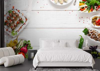 Appetizing vegetarian snacks, free space. Tasty vegetable meals variety on white wooden background with copy space in center. Menu, cuisine, kitchen concept Wall mural